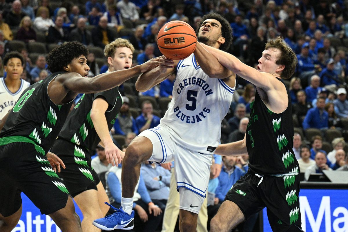 Nov 19, 2025; Omaha, Nebraska, USA; North Dakota Fighting Hawks guard Greyson Uelmen (3) fouls Creighton Bluejays guard Nik Graves (5) on a shot attempt during the second half at CHI Health Center Omaha. Mandatory Credit: Steven Branscombe-Imagn Images