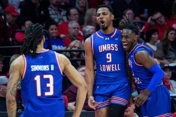 UMass Lowell’s Angel Montas Jr. (9) celebrates his last-second three-pointer against Bradley to end the first half of their college basketball game Wednesday, Nov. 19, 2025 at Carver Arena in Peoria. The Braves rallied to defeat the River Hawks 87-77.