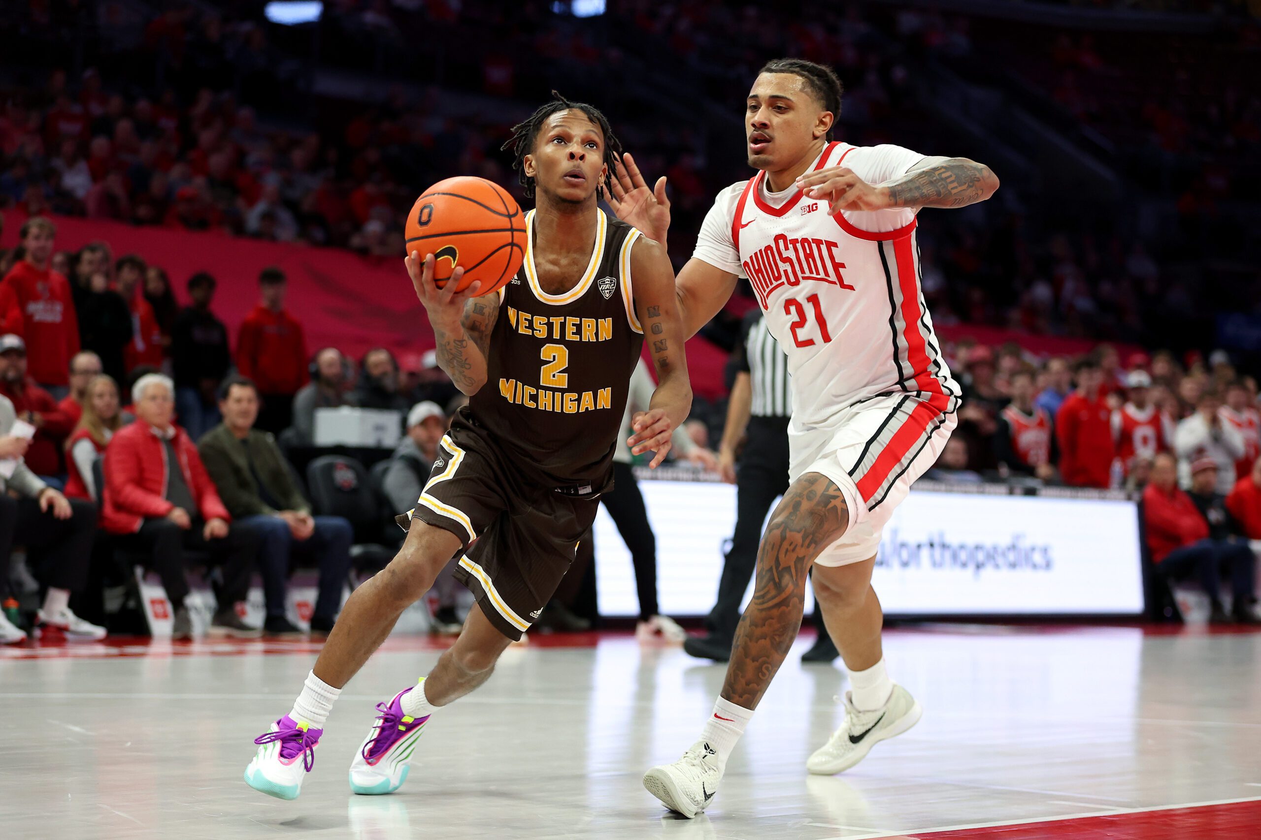 Nov 20, 2025; Columbus, Ohio, USA; Western Michigan Broncos guard Jalen Griffith (2) goes to the basket as Ohio State Buckeyes forward Devin Royal (21) defends during the first half at Value City Arena. Mandatory Credit: Joseph Maiorana-Imagn Images