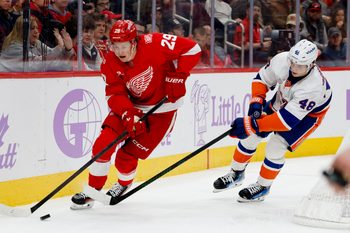 Nov 20, 2025; Detroit, Michigan, USA;  Detroit Red Wings center Nate Danielson (29) skates with the puck defended by New York Islanders defenseman Matthew Schaefer (48) in the second period at Little Caesars Arena. Mandatory Credit: Rick Osentoski-Imagn Images