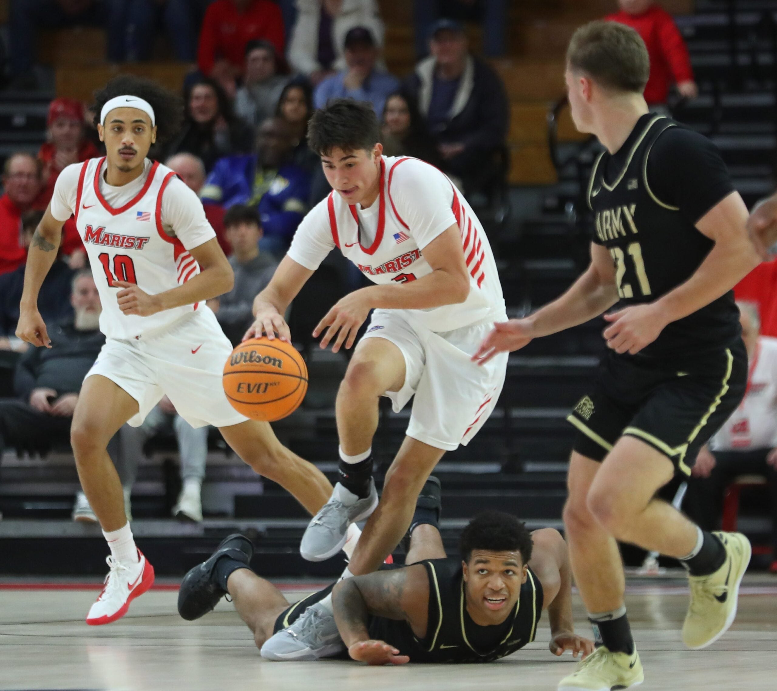 Marist’s Justin Menard dribbles over Army’s Jacen Holloway during their game on November 21, 2025.