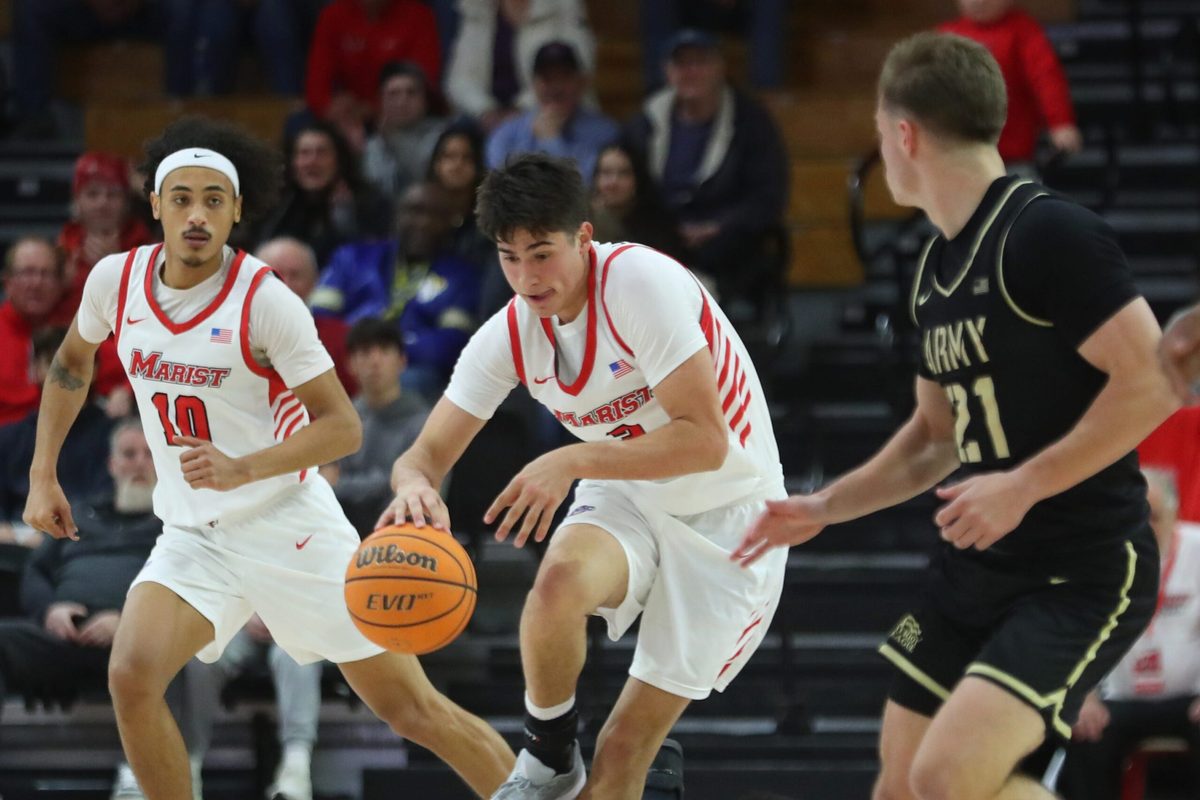 Marist’s Justin Menard dribbles over Army’s Jacen Holloway during their game on November 21, 2025.