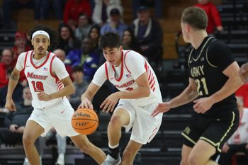 Marist’s Justin Menard dribbles over Army’s Jacen Holloway during their game on November 21, 2025.