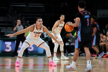 Nov 23, 2025; Coral Gables, Florida, USA; Miami Hurricanes guard Dante Allen (35) defends against Delaware State Hornets guard Ponce James (1) during the first half at Watsco Center. Mandatory Credit: Sam Navarro-Imagn Images