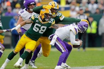 Nov 23, 2025; Green Bay, Wisconsin, USA; Green Bay Packers' Isaiah McDuffie (58) and Warren Brinson (91) sack Minnesota Vikings quarterback J.J. McCarthy (9) in the second quarter during their football game at Lambeau Field. Mandatory Credit: Dan Powers-USA TODAY Network via Imagn Images