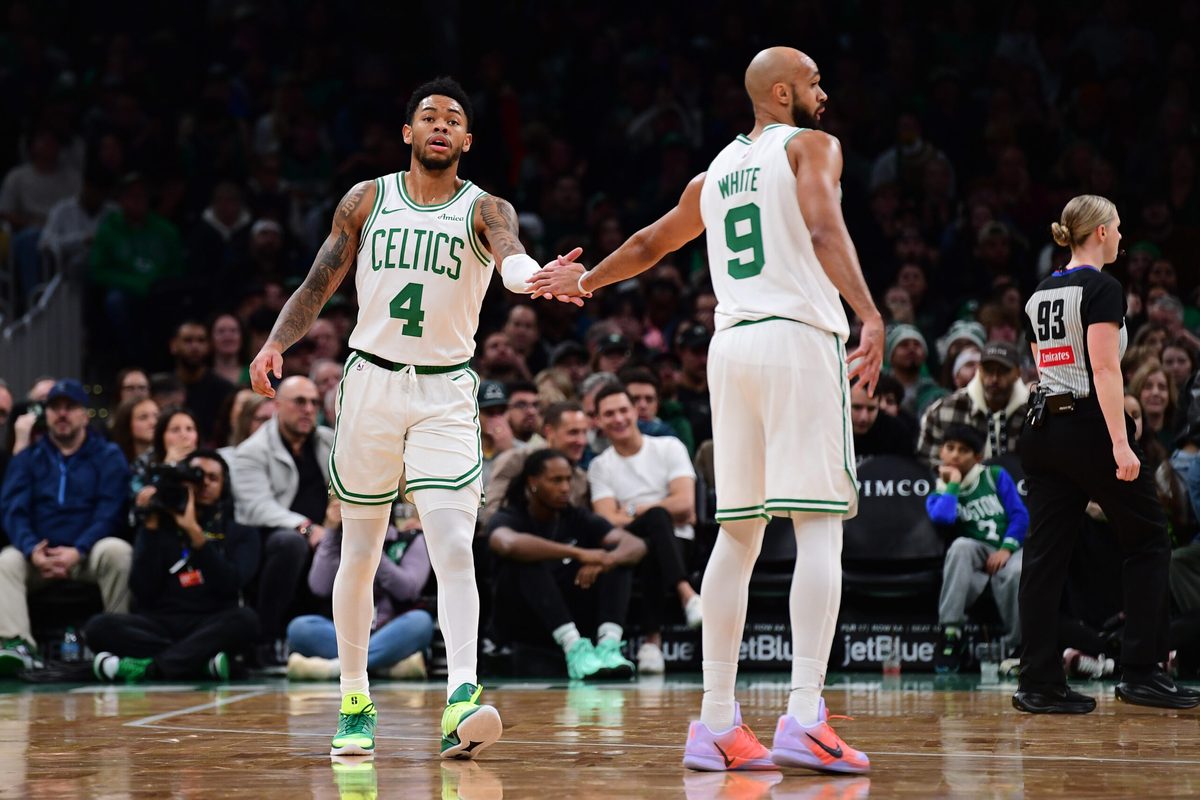 Nov 23, 2025; Boston, Massachusetts, USA; Boston Celtics guard Anfernee Simons (4) is congratulated by guard Derrick White (9) after a basket during the first half at TD Garden. Mandatory Credit: Bob DeChiara-Imagn Images