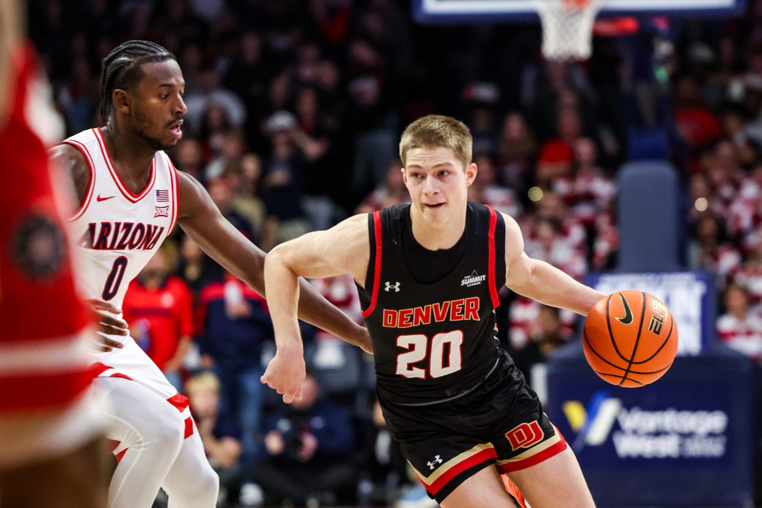 Nov 24, 2025; Tucson, Arizona, USA; Denver Pioneers guard Carson Johnson (20) dribbles the ball during the first half of the game against the Arizona Wildcats at McKale Memorial Center. Mandatory Credit: Aryanna Frank-Imagn Images