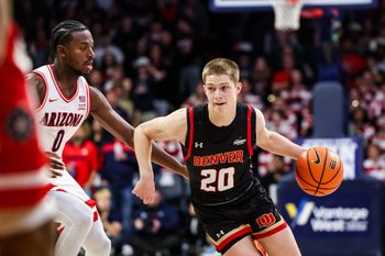 Nov 24, 2025; Tucson, Arizona, USA; Denver Pioneers guard Carson Johnson (20) dribbles the ball during the first half of the game against the Arizona Wildcats at McKale Memorial Center. Mandatory Credit: Aryanna Frank-Imagn Images