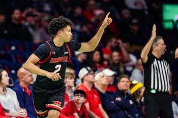 Nov 24, 2025; Tucson, Arizona, USA; Denver Pioneers guard Devin Carney (2) points up after he makes a three pointer during the second half of the game against the Arizona Wildcats at McKale Memorial Center. Mandatory Credit: Aryanna Frank-Imagn Images