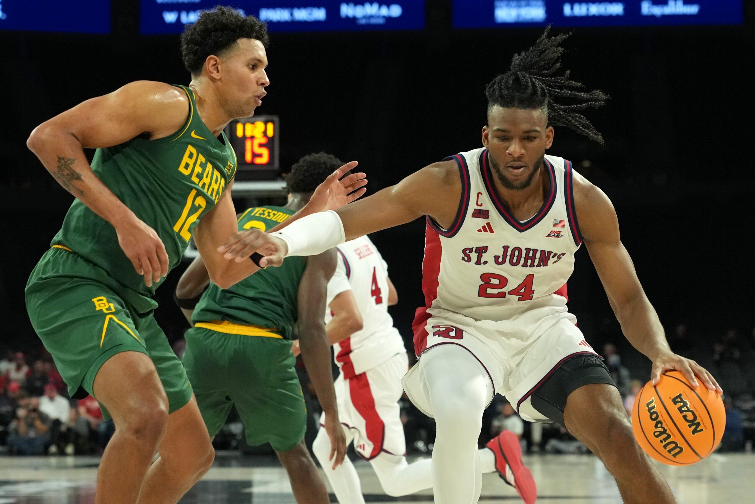 Nov 25, 2025; Las Vegas, Nevada, USA; St. John's Red Storm forward Zuby Ejiofor (24) dribbles the ball against Baylor Bears guard Michael Rataj (12) in a 2025 Players Era Festival group play game at Michelob Ultra Arena. Mandatory Credit: Kirby Lee-Imagn Images