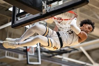 UW-Milwaukee guard Seth Hubbard (12) hangs on the rim after dunking against Dominican in a game Tuesday, November 25, 2025, at the Klotsche Center in Milwaukee, Wisconsin.