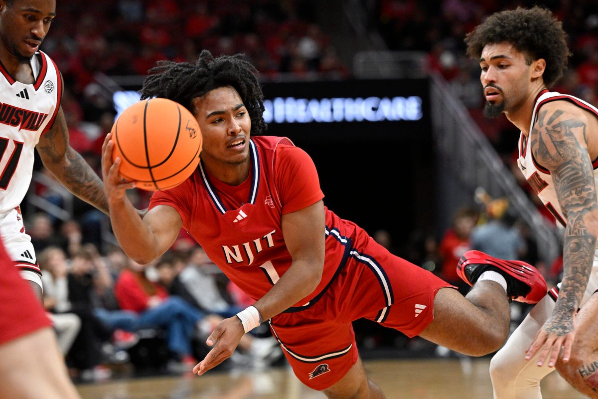 Nov 26, 2025; Louisville, Kentucky, USA;  NJIT Highlanders guard David Bolden (1) tries to pass against Louisville Cardinals guard J'Vonne Hadley (1) during the first half at KFC Yum! Center. Mandatory Credit: Jamie Rhodes-Imagn Images