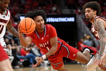Nov 26, 2025; Louisville, Kentucky, USA;  NJIT Highlanders guard David Bolden (1) tries to pass against Louisville Cardinals guard J'Vonne Hadley (1) during the first half at KFC Yum! Center. Mandatory Credit: Jamie Rhodes-Imagn Images