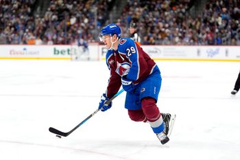 Nov 26, 2025; Denver, Colorado, USA; Colorado Avalanche center Nathan MacKinnon (29) controls the puck in the second period against the San Jose Sharks at Ball Arena. Mandatory Credit: Ron Chenoy-Imagn Images