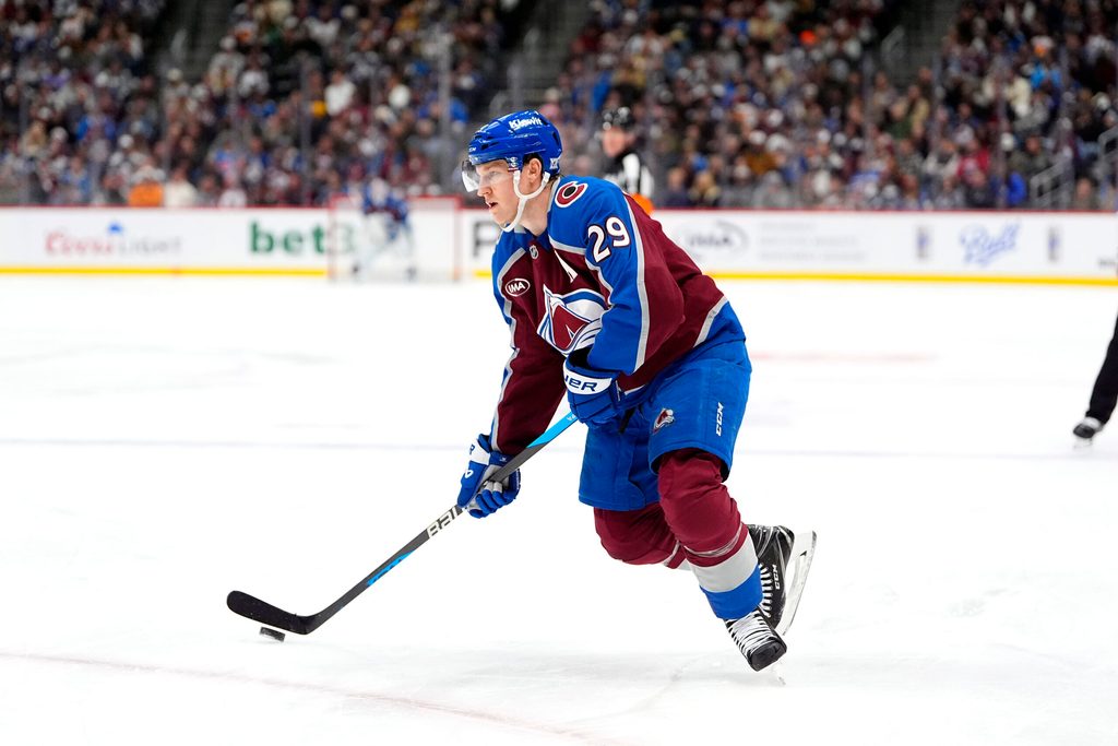 Nov 26, 2025; Denver, Colorado, USA; Colorado Avalanche center Nathan MacKinnon (29) controls the puck in the second period against the San Jose Sharks at Ball Arena. Mandatory Credit: Ron Chenoy-Imagn Images