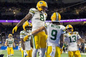 Nov 27, 2025; Detroit, Michigan, USA; Green Bay Packers running back Josh Jacobs (8) and Green Bay Packers wide receiver Christian Watson (9) celebrate after a touchdown against the Detroit Lions during the third quarter at Ford Field. Mandatory Credit: David Reginek-Imagn Images