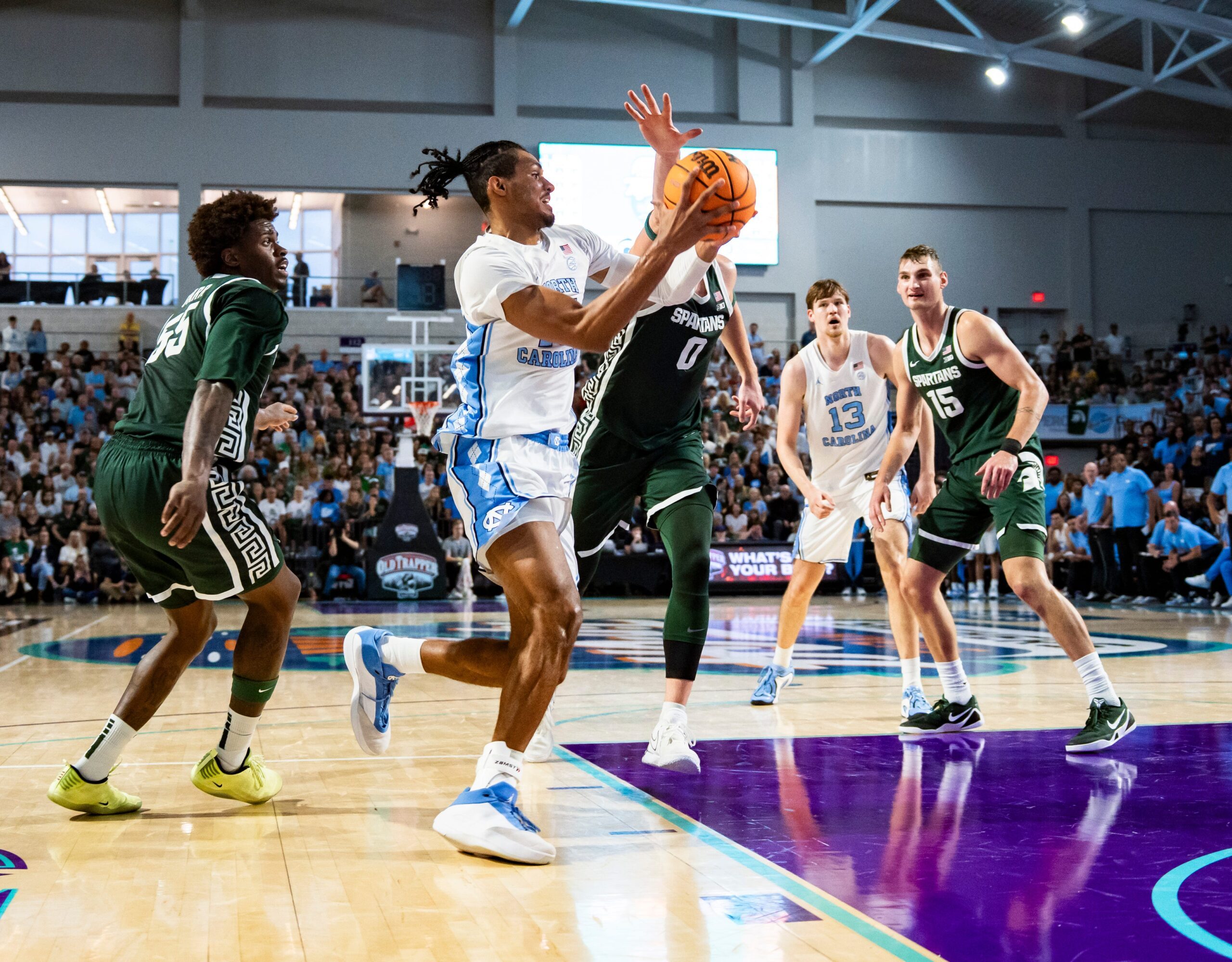 North Carolina Tar Heels forward Jarin Stevenson (15) drives to the basket as Michigan State Spartans forward Jaxon Kohler (0) guards him during the first half of the Fort Myers Tip-Off Beach Division game at Suncoast Credit Union Arena on Fort Myers, Fla., on Thursday, Nov. 27, 2025.