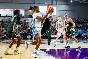 North Carolina Tar Heels forward Jarin Stevenson (15) drives to the basket as Michigan State Spartans forward Jaxon Kohler (0) guards him during the first half of the Fort Myers Tip-Off Beach Division game at Suncoast Credit Union Arena on Fort Myers, Fla., on Thursday, Nov. 27, 2025.