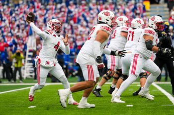 Nov 28, 2025; Lawrence, Kansas, USA; Utah Utes quarterback Devon Dampier (4) throws a pass during the first half against the Kansas Jayhawks at David Booth Kansas Memorial Stadium. Mandatory Credit: Jay Biggerstaff-Imagn Images
