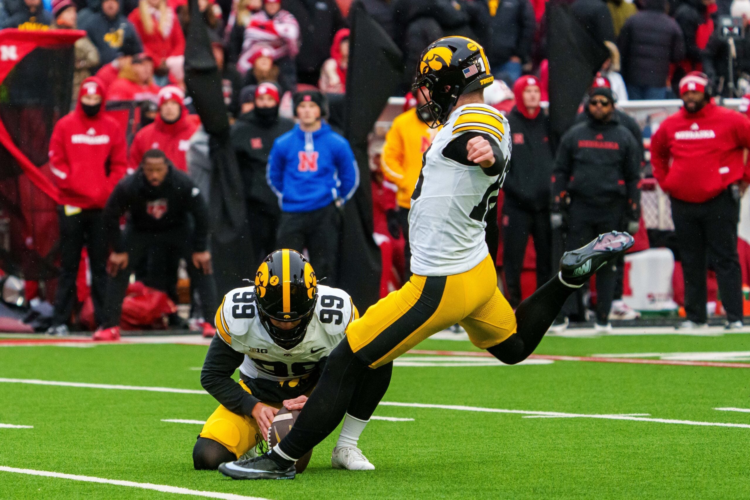 Nov 28, 2025; Lincoln, Nebraska, USA; Iowa Hawkeyes kicker Drew Stevens (18) kicks a PAT against the Nebraska Cornhuskers during the fourth quarter at Memorial Stadium. Mandatory Credit: Dylan Widger-Imagn Images