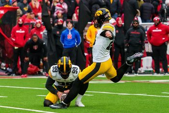 Nov 28, 2025; Lincoln, Nebraska, USA; Iowa Hawkeyes kicker Drew Stevens (18) kicks a PAT against the Nebraska Cornhuskers during the fourth quarter at Memorial Stadium. Mandatory Credit: Dylan Widger-Imagn Images