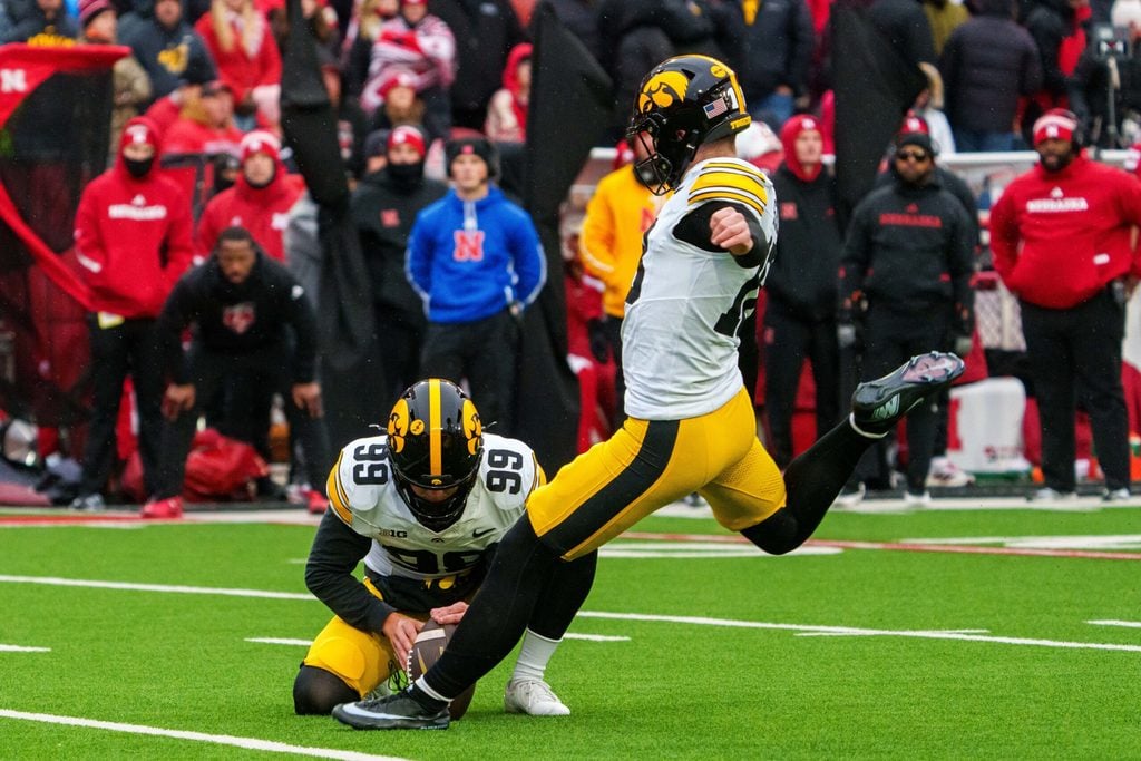 Nov 28, 2025; Lincoln, Nebraska, USA; Iowa Hawkeyes kicker Drew Stevens (18) kicks a PAT against the Nebraska Cornhuskers during the fourth quarter at Memorial Stadium. Mandatory Credit: Dylan Widger-Imagn Images