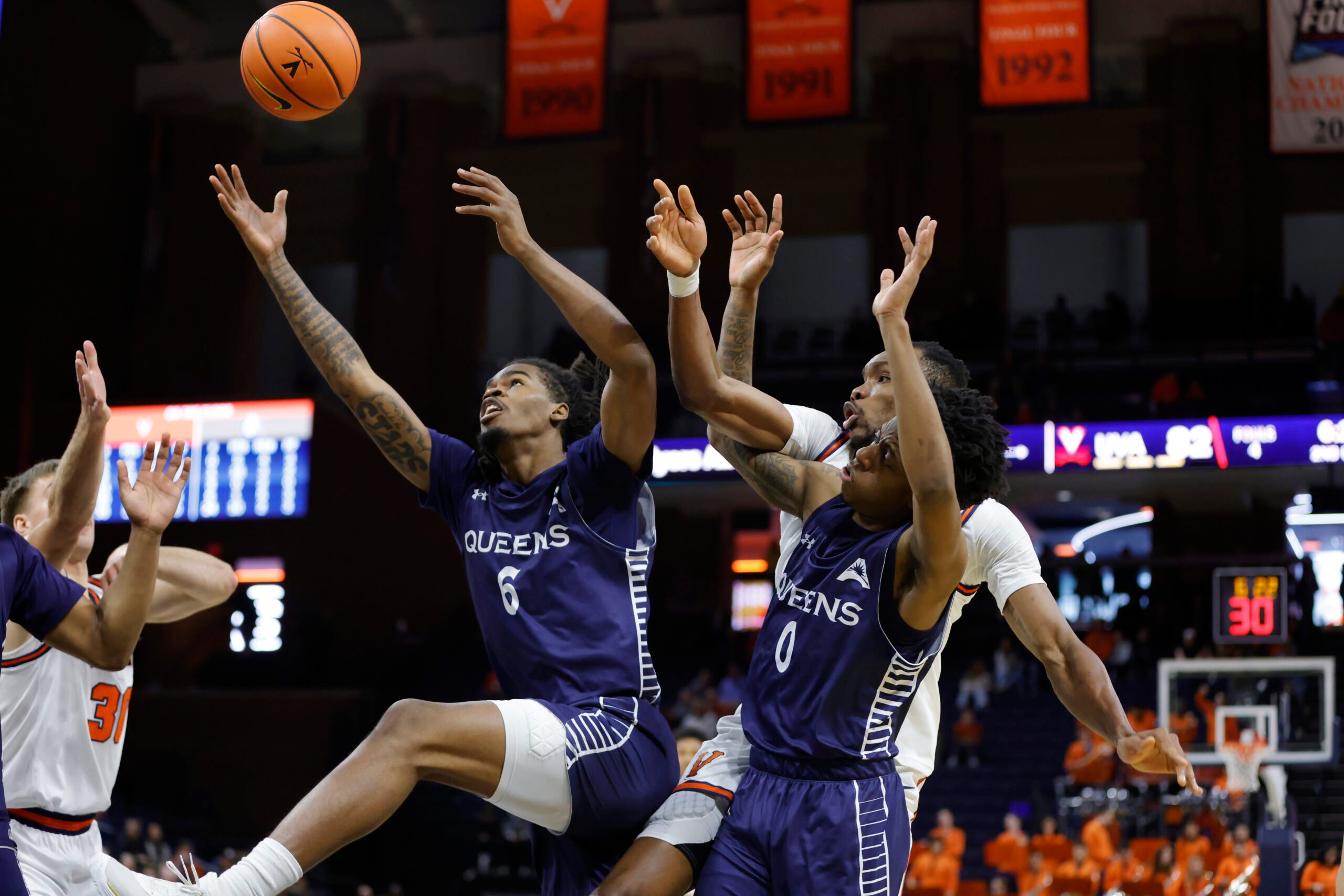 Nov 28, 2025; Charlottesville, Virginia, USA; Queens University of Charlotte Royals forward Avantae Parker (6) and Royals guard Jordan Watford (0) battles for the ball with Virginia Cavaliers center Ugonna Onyenso (33) during the second half at John Paul Jones Arena. Mandatory Credit: Amber Searls-Imagn Images