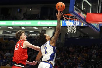 Nov 28, 2025; Pittsburgh, Pennsylvania, USA;  Pittsburgh Panthers forward Cameron Corhen (2) shoots against Ohio State Buckeyes center Christoph Tilly (13) during the first half at the Petersen Events Center. Mandatory Credit: Charles LeClaire-Imagn Images