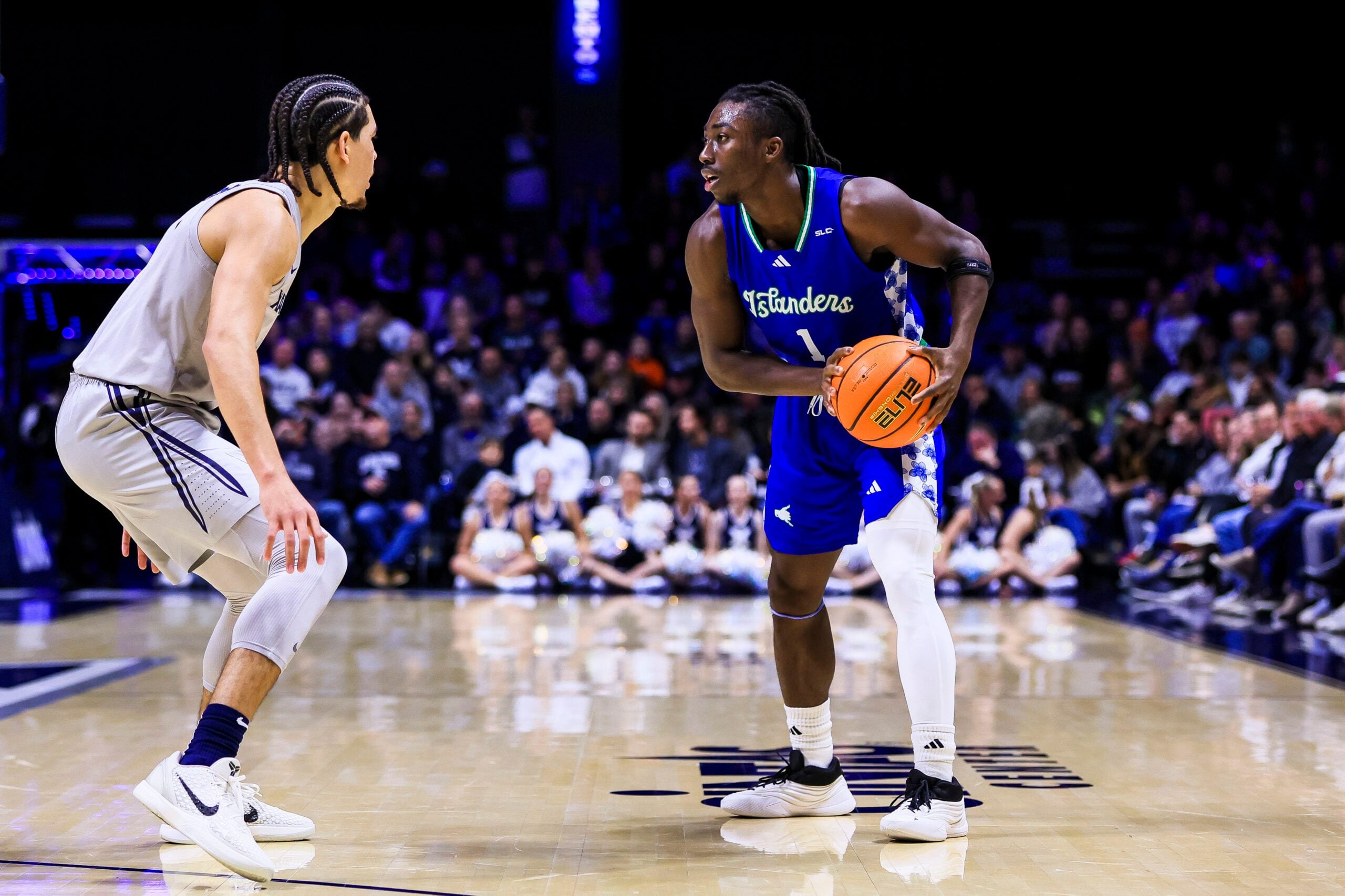 Nov 28, 2025; Cincinnati, Ohio, USA; Texas A&M-Corpus Christi Islanders guard Nick Shogbonyo (1) holds the ball against Xavier Musketeers guard Malik Messina-Moore (1) in the first half at Cintas Center. Mandatory Credit: Katie Stratman-Imagn Images