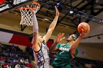 Nov 28, 2025; Kissimmee, FL, USA; Miami (FL) Hurricanes forward Shelton Henderson (7) shoots the ball over Georgetown Hoyas forward Caleb Williams (4) in the second half during the ESPN Events Invitational at State Farm Field House. Mandatory Credit: Nathan Ray Seebeck-Imagn Images