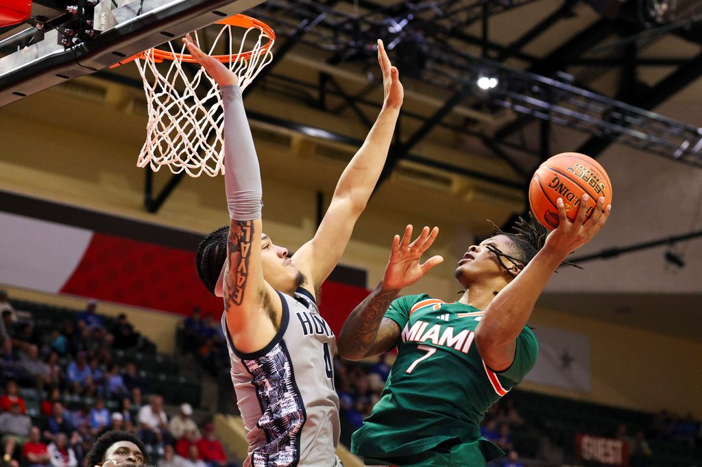 Nov 28, 2025; Kissimmee, FL, USA; Miami (FL) Hurricanes forward Shelton Henderson (7) shoots the ball over Georgetown Hoyas forward Caleb Williams (4) in the second half during the ESPN Events Invitational at State Farm Field House. Mandatory Credit: Nathan Ray Seebeck-Imagn Images