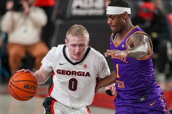 Nov 29, 2025; Athens, Georgia, USA; Georgia Bulldogs guard Blue Cain (0) dribbles against Tennessee Tech Golden Eagles guard Mekhi Cameron (1) during the second half at Stegeman Coliseum. Mandatory Credit: Dale Zanine-Imagn Images