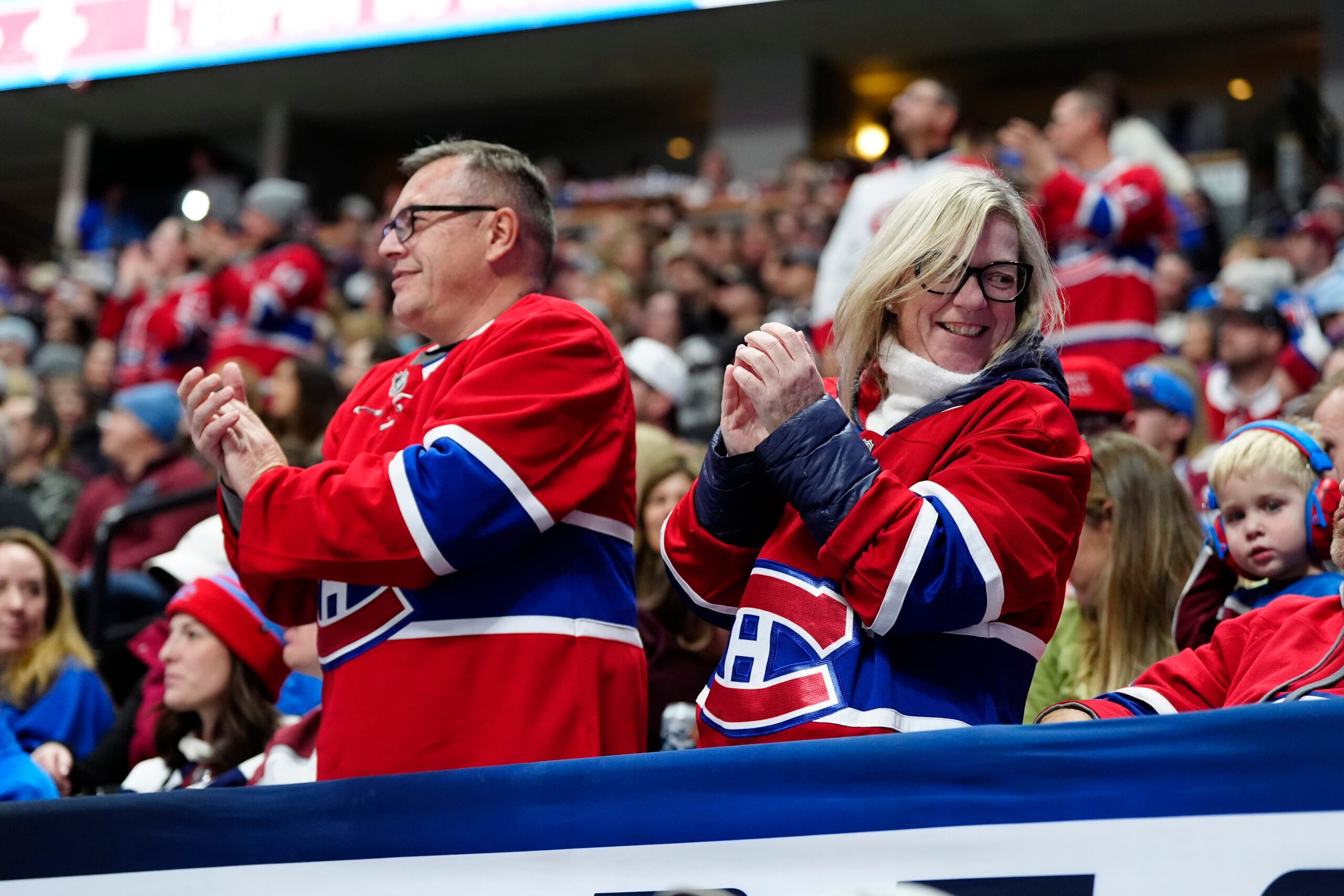 Nov 29, 2025; Denver, Colorado, USA; Montreal Canadiens fans celebrate a goal scored in the third period against the Montreal Canadiens at Ball Arena. Mandatory Credit: Ron Chenoy-Imagn Images