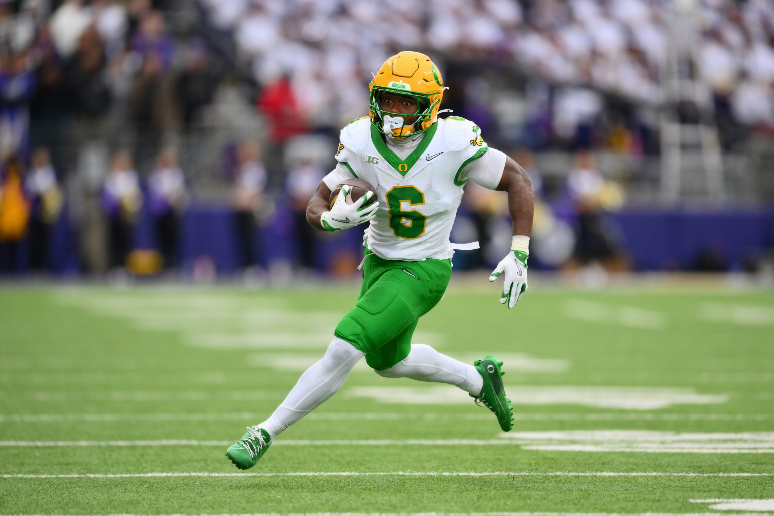 Nov 29, 2025; Seattle, Washington, USA; Oregon Ducks running back Noah Whittington (6) carries the ball against the Washington Huskies during the first half at Husky Stadium. Mandatory Credit: Steven Bisig-Imagn Images