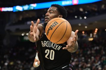 Nov 29, 2025; Milwaukee, Wisconsin, USA; Brooklyn Nets center Day'Ron Sharpe (20) reaches for the ball in the third quarter against the Milwaukee Bucks at Fiserv Forum. Mandatory Credit: Benny Sieu-Imagn Images