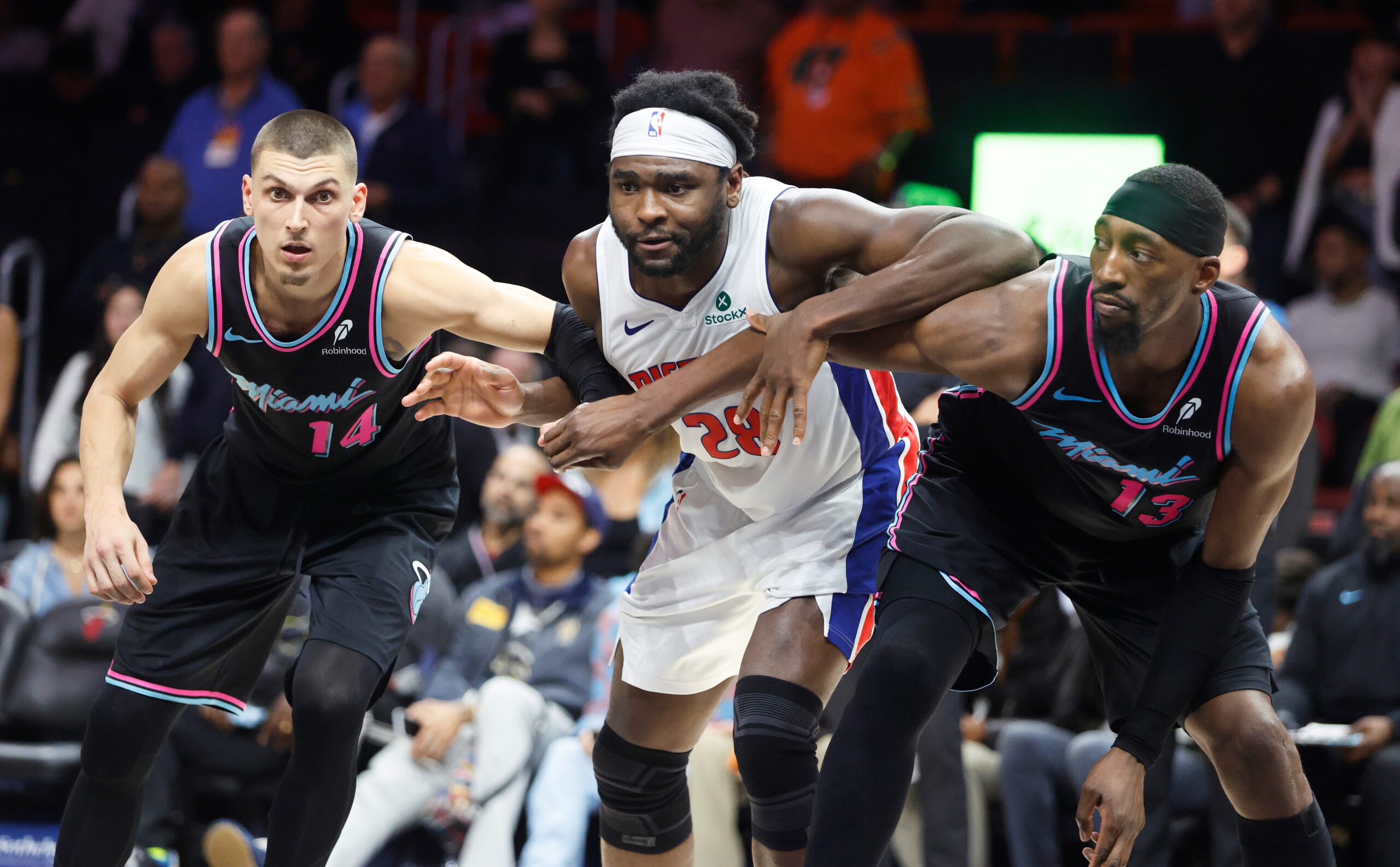 Nov 29, 2025; Miami, Florida, USA; Miami Heat guard Tyler Herro (14) and center Bam Adebayo (13) vie for position against Detroit Pistons forward Isaiah Stewart (28) during the second half at Kaseya Center. Mandatory Credit: Rhona Wise-Imagn Images