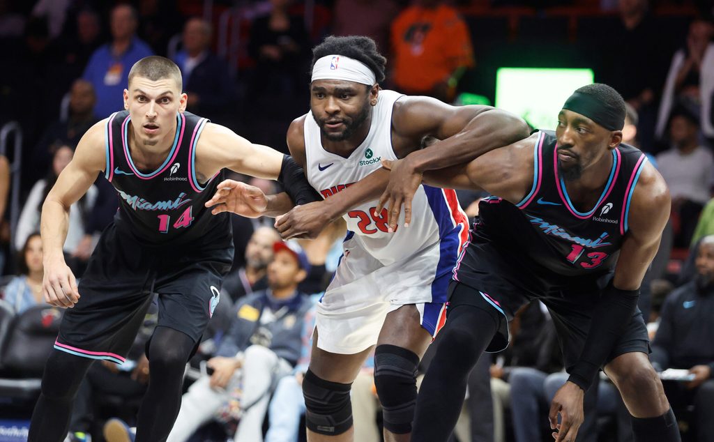 Nov 29, 2025; Miami, Florida, USA; Miami Heat guard Tyler Herro (14) and center Bam Adebayo (13) vie for position against Detroit Pistons forward Isaiah Stewart (28) during the second half at Kaseya Center. Mandatory Credit: Rhona Wise-Imagn Images