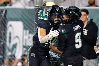 Nov 29, 2025; Honolulu, Hawaii, USA; Hawaii Rainbow Warriors wide receiver Jackson Harris (9) celebrates with running back Landon Sims (30) after scoring a touchdown against the Wyoming Cowboys during the second quarter at Clarence T.C. Ching Athletics Complex. Mandatory Credit: Marco Garcia-Imagn Images