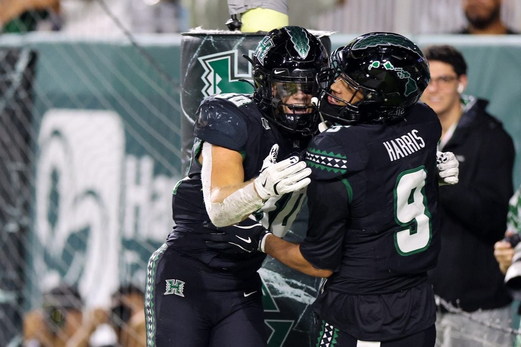 Nov 29, 2025; Honolulu, Hawaii, USA; Hawaii Rainbow Warriors wide receiver Jackson Harris (9) celebrates with running back Landon Sims (30) after scoring a touchdown against the Wyoming Cowboys during the second quarter at Clarence T.C. Ching Athletics Complex. Mandatory Credit: Marco Garcia-Imagn Images