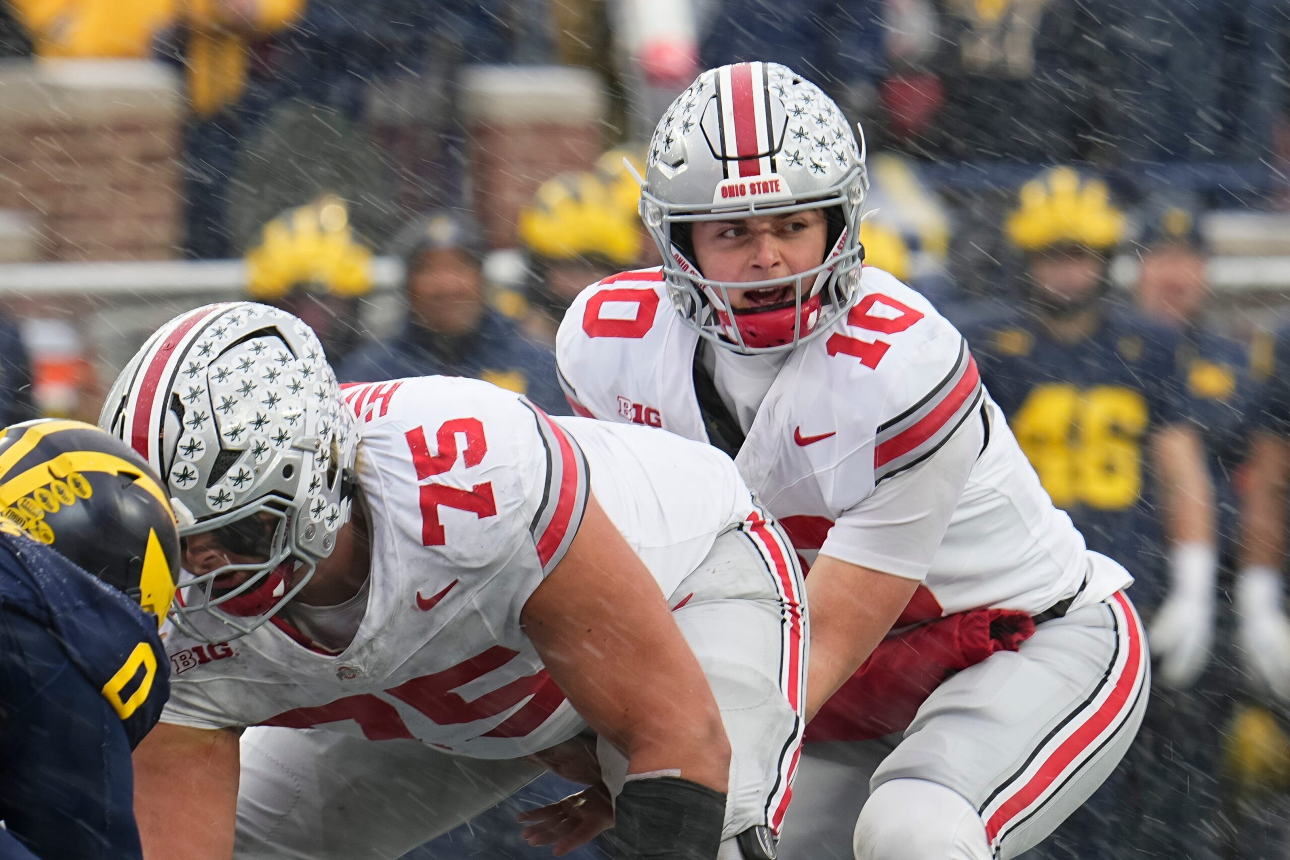 Ohio State Buckeyes quarterback Julian Sayin (10) takes a snap from offensive lineman Carson Hinzman (75) during the NCAA football game against the Michigan Wolverines at Michigan Stadium in Ann Arbor, Mich. on Nov. 29, 2025. Ohio State won 27-9.