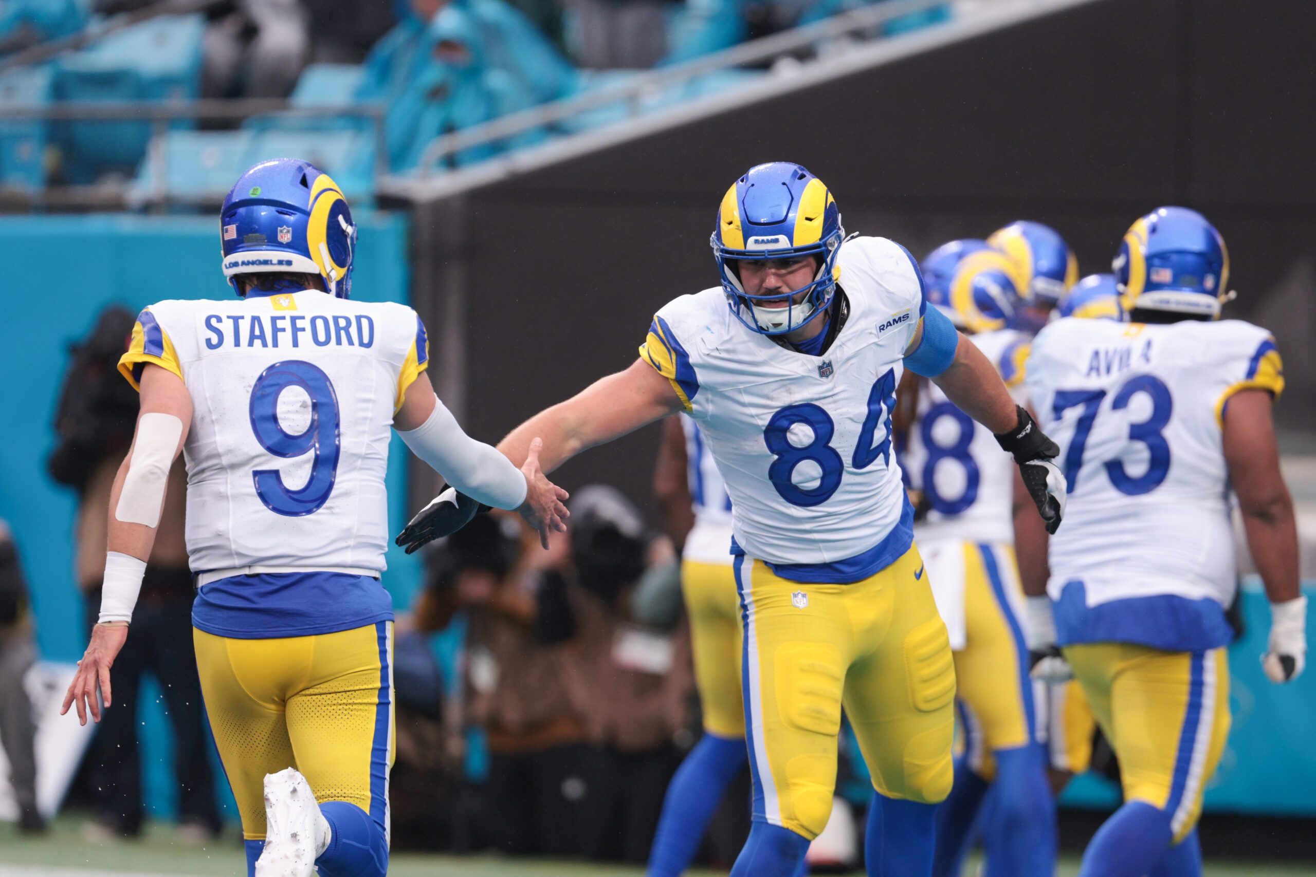 Nov 30, 2025; Charlotte, North Carolina, USA; Los Angeles Rams tight end Colby Parkinson (84) celebrates with Los Angeles Rams quarterback Matthew Stafford (9) during the fourth quarter against the Carolina Panthers at Bank of America Stadium. Mandatory Credit: Scott Kinser-Imagn Images