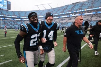 Nov 30, 2025; Charlotte, North Carolina, USA; Carolina Panthers safety Nick Scott (21) and Carolina Panthers quarterback Andy Dalton (14) celebrate after the game against the Los Angeles Rams at Bank of America Stadium. Mandatory Credit: Scott Kinser-Imagn Images