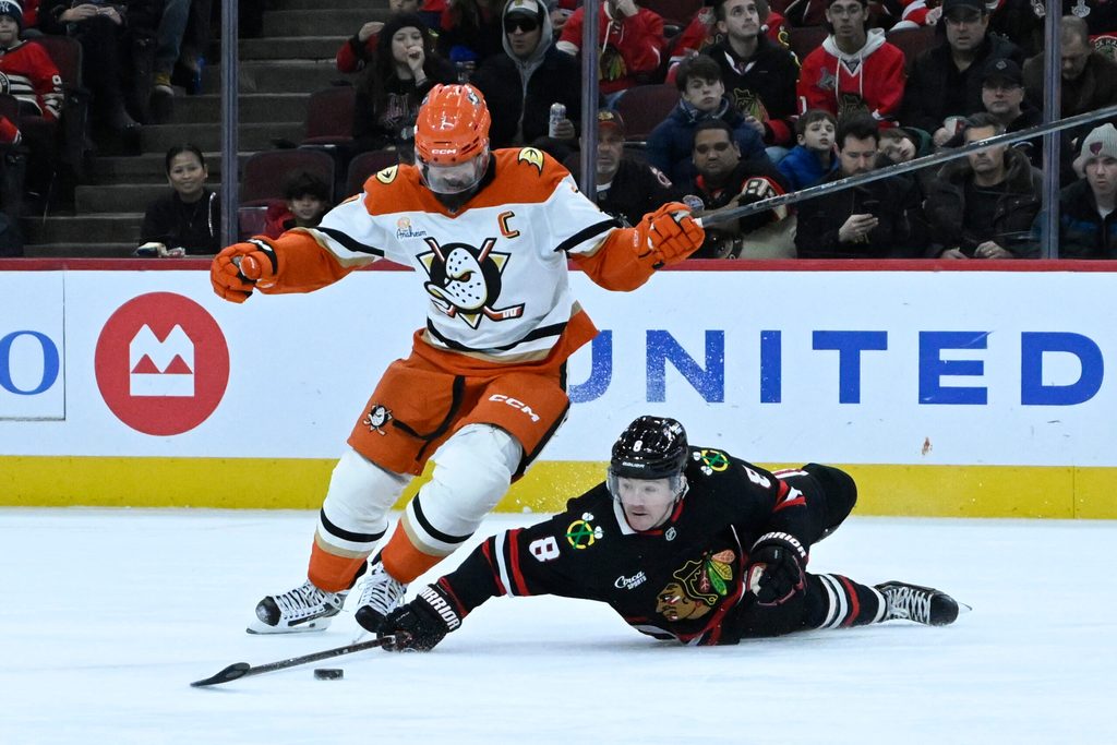 Nov 30, 2025; Chicago, Illinois, USA; Anaheim Ducks defenseman Radko Gudas (7) and Chicago Blackhawks center Ryan Donato (8) chase the puck during the first period at United Center. Mandatory Credit: Matt Marton-Imagn Images