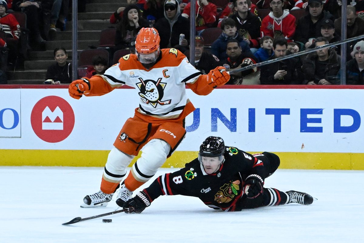 Nov 30, 2025; Chicago, Illinois, USA; Anaheim Ducks defenseman Radko Gudas (7) and Chicago Blackhawks center Ryan Donato (8) chase the puck during the first period at United Center. Mandatory Credit: Matt Marton-Imagn Images