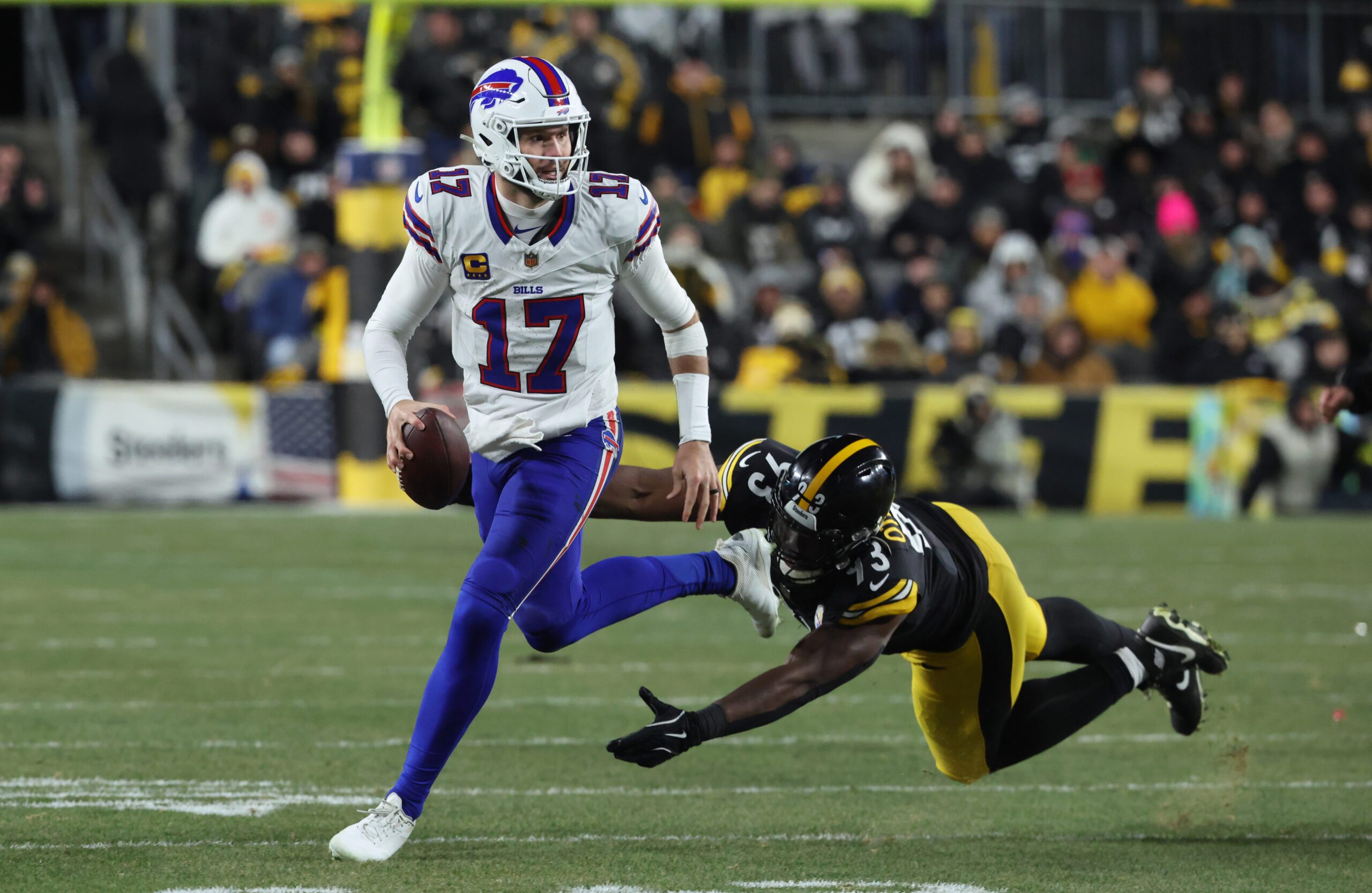 Nov 30, 2025; Pittsburgh, Pennsylvania, USA; Buffalo Bills quarterback Josh Allen (17) looks to pass as Pittsburgh Steelers defensive end Esezi Otomewo (93) attempts to tackle during the second quarter at Acrisure Stadium. Mandatory Credit: Charles LeClaire-Imagn Images