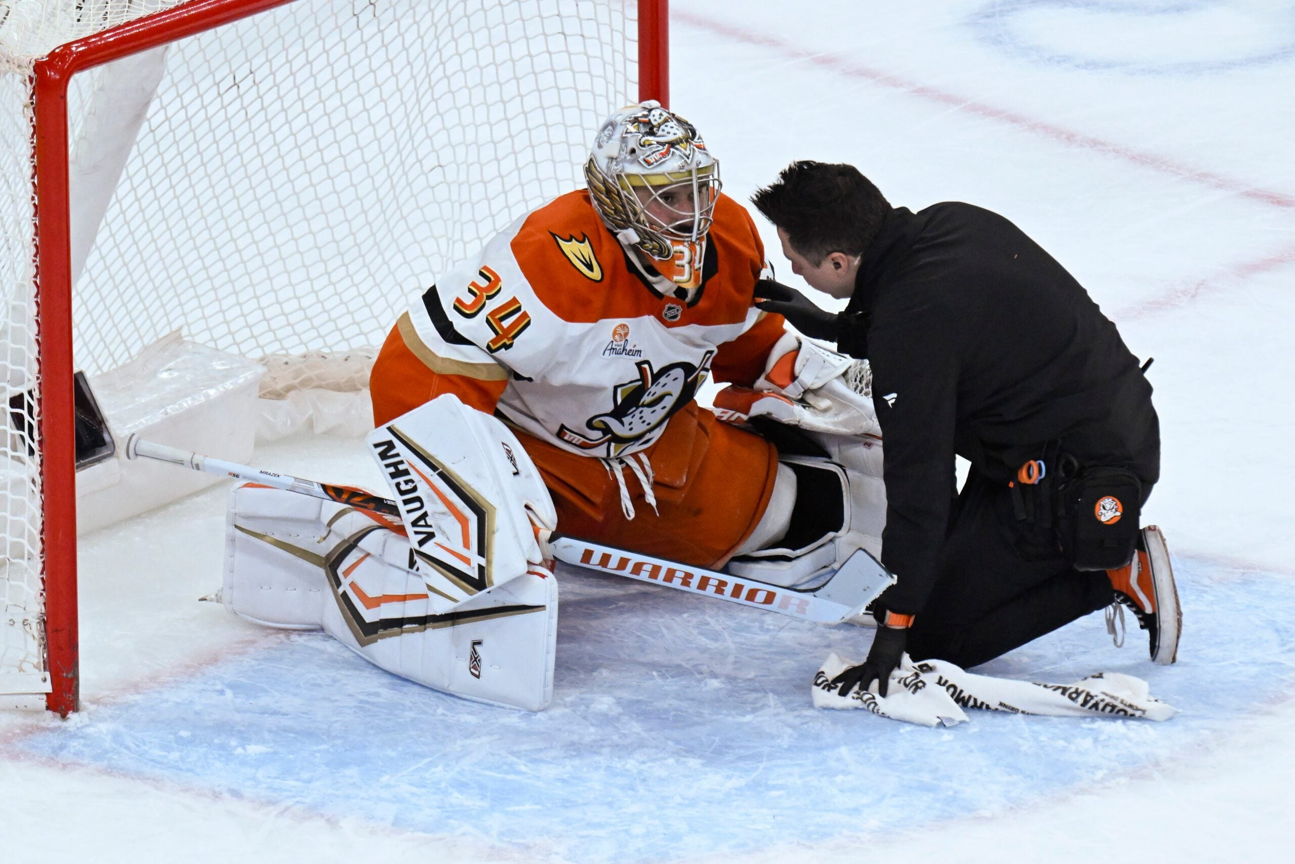 Nov 30, 2025; Chicago, Illinois, USA;  Anaheim Ducks goaltender Petr Mrazek (34) talks with a team member after being injured during the third period against the  Chicago Blackhawks at United Center. Mandatory Credit: Matt Marton-Imagn Images
