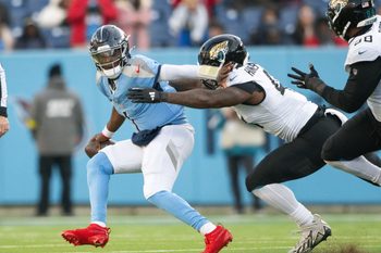 Nov 30, 2025; Nashville, Tennessee, USA;  Jacksonville Jaguars defensive end Josh Hines-Allen (41) sacks Tennessee Titans quarterback Cameron Ward (1) during the second half at Nissan Stadium. Mandatory Credit: Steve Roberts-Imagn Images