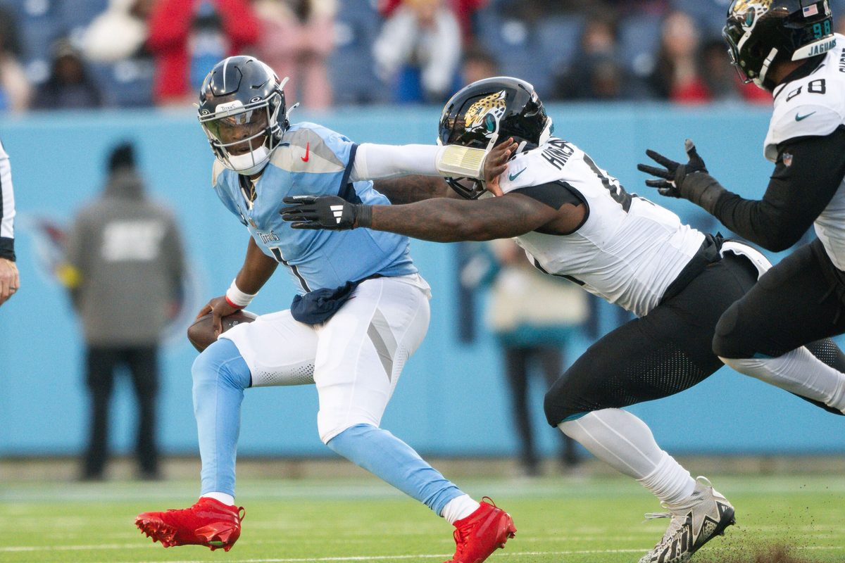 Nov 30, 2025; Nashville, Tennessee, USA; Jacksonville Jaguars defensive end Josh Hines-Allen (41) sacks Tennessee Titans quarterback Cameron Ward (1) during the second half at Nissan Stadium. Mandatory Credit: Steve Roberts-Imagn Images