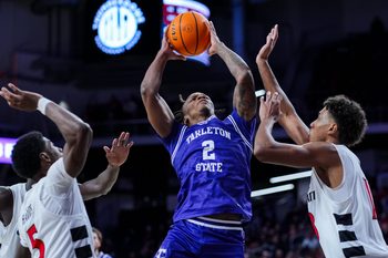 Dec 1, 2025; Cincinnati, Ohio, USA;  Tarleton State Texans guard Freddy Hicks (2) drives to the basket against Cincinnati Bearcats forward Baba Miller (18) in the second half at Fifth Third Arena. Mandatory Credit: Aaron Doster-Imagn Images