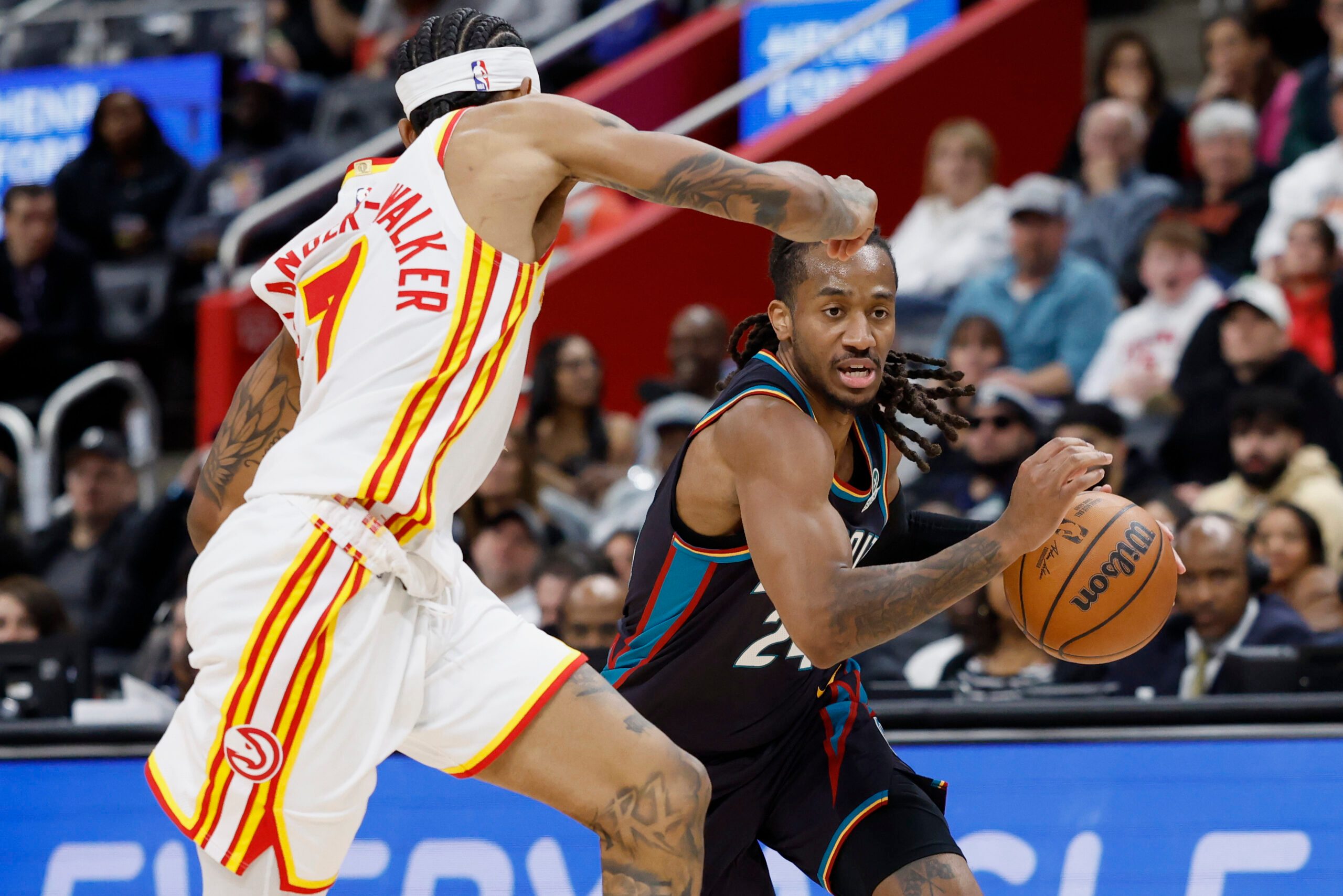 Dec 1, 2025; Detroit, Michigan, USA;  Detroit Pistons guard Daniss Jenkins (24) dribbles defended by Atlanta Hawks guard Nickeil Alexander-Walker (7) in the second half at Little Caesars Arena. Mandatory Credit: Rick Osentoski-Imagn Images
